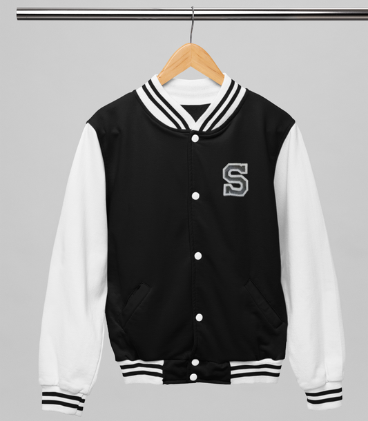 Black and white varsity jacket with a letter 'S' on a hanger against a gray background